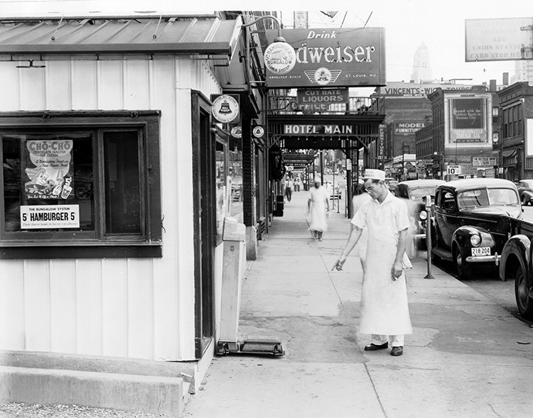 Employee outside a Bungalow location at 1432 Main, 1940.